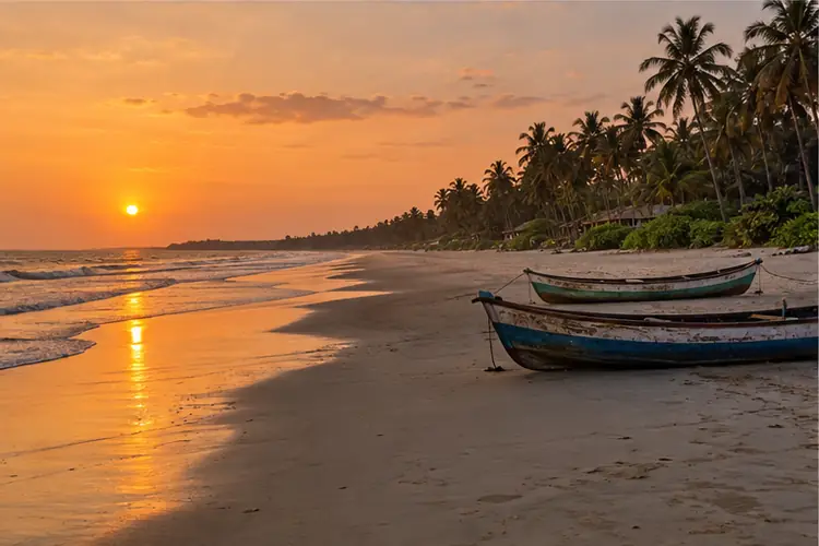 Colva beach in South Goa at sunset with fishing canoes
